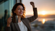 © Maksym - Solo businesswoman celebrates successful grant approval alone in minimalist studio apartment raising coffee mug toward spring sunrise streaming through window, ideal for entreprene