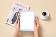 © Pixel-Shot - Female hands with tablet computer, cup of coffee and fashion magazine on beige background