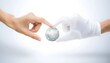 © obscuronata - Close up of two hands exchanging a small globe on a white background.