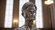 © MstMoyna - A Shiny Metal Statue Of A Person With A Metal Band Over Their Eyes Is Seen