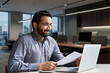 © insta_photos - Smiling indian business man hr employer, teacher or lawyer holding cv document having virtual job interview meeting by video conference call, consulting client on laptop at online legal advice.