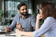 © insta_photos - Interview of happy smiling indian hr manager with latin young professional and friendly support discussing job cv. Mentoring Hispanic male teacher and female student in multiethnic creative space.