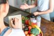 © buritora - A woman's hands taking notes in a cooking class/cooking school.