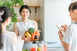 © buritora - An athlete food master explains the nutritional content of vegetables, green and yellow vegetables, and fruits in a cooking class.