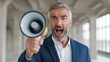 © INSPIRIA.K - Man shouting into megaphone to make announcement. Businessman with beard holding loudspeaker for marketing campaign. Corporate communication and leadership concept. Professional promotion tool.