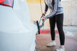 © ADDICTIVE STOCK - Teenager washing a foamy car with brush at car wash