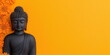 © Phanupong - Peaceful Black Buddha Statue With Orange Flowers on Vibrant Yellow Background copy space