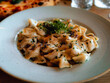 © ArboursAbroad.com - Creamy Pasta Dish Close-Up, Idrija zlikrofi, Dumpling, Gourmet Slovenian Food with Herbs and Sauce
