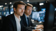 © forenna - IT security team in server room examining ransomware encryption patterns on monitors, backup systems highlighted, disaster recovery protocols displayed, urgent nighttime atmosphere, ideal for cybers