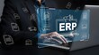 © Jignesh - Businessman using laptop with erp enterprise resource planning software interface and icons floating around