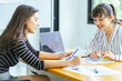 © chokniti - Business team meeting discussion collaboration presenting data analysis corporate teamwork diverse professionals planning strategy office communication partnership
