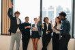 © chokniti - Business team celebrating success in office happy diverse professionals raising hands teamwork achievement corporate victory collaboration motivation workplace energy