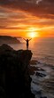 © Yuliia - Woman silhouette with raised arms celebrating freedom on cliff edge during golden sunset over ocean waves. Inspirational achievement and success concept.
