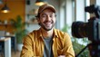 © Vadym - Smiling man records video testimonial. Young guy in casual cap and shirt speaks into camera. Modern office background, interview setup. Authentic presentation style.