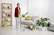 © New Africa - Spring cleaning. Woman tidying up floor with mop at home
