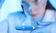 © New Africa - Scientist dripping liquid sample into Petri dish on light background, closeup