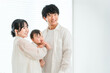 © buritora - A young Asian couple, family, parent and child, holding their baby at home.