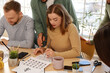 © Pixel-Shot - Group of young people during courses of calligraphy