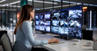 © Andrey Popov - Female Security Officer Monitoring Several Surveillance Screens