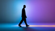 © Curioso.Photography - Man walking silhouette on colorful gradient background representing modern lifestyle and motion concept.