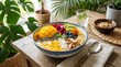 © nabisha - A vibrant and healthy breakfast bowl filled with fresh fruits and granola on a wooden table surrounded by lush green plants