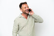 © luismolinero - Middle age caucasian man isolated on white background keeping a conversation with the mobile phone