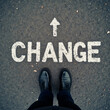 © MPSseven - Standing at road word painted CHANGE with arrow pointing forward suggesting point to move and embrace personal change and new direction in life