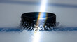 © juicy - Close up of hockey puck on ice with ice chips flying.