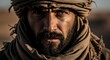 © Best image  - Portrait of nomadic man with scarf in harsh desert environment