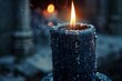 © juliars - Black candle burning and dripping hot wax with smoke and blurred background in a cemetery at dusk