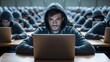 © MHA Creation - Young man in hoodie focused on laptop in classroom setting with peers