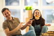© milanmarkovic78 - Couple enjoys pizza and cookies while sitting on the floor in their home during a fun moment together