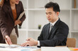 © aekachai - Professional Asian Businesswoman Conducting an Interview or Meeting in a Modern Office