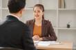 © aekachai - Professional Asian Businesswoman Conducting an Interview or Meeting in a Modern Office