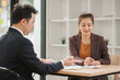 © aekachai - Professional Asian Businesswoman Conducting an Interview or Meeting in a Modern Office