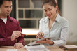 © aekachai - Professional Asian Business Colleagues Discussing Work Projects Using Tablet in Office