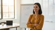 © SHAPLA - Professional woman confidently standing in front of a planning whiteboard
