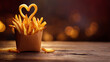 © Bonsales - French fried potatoes arranged in a brown paper box, a single fry creating a heart, on a rustic wood surface