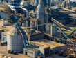 © Amazing Aerial - Aerial view of industrial facility with silos, conveyors, and machinery processing wood byproducts. Recycling materials, Grajewo, Podlaskie Voivodeship, Poland.