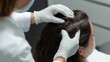 © Dace - Dermatologist examining patient's scalp for hair health condition