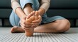 © A.waisi - Painful foot massage at home, woman holding aching sole with hands, plantar fasciitis concept, person suffering from foot pain on carpet