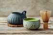 © GHArtwork - A minimalist Japanese tea set with green tea powder and a traditional bamboo whisk
