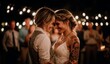 © woters - Couple with foreheads touching shares a warm embrace at a wedding under string lights