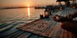 © Rehman - Hands pressing into yoga mat on dock at sunrise symbolizing energy and grounding