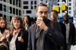© DC Studio - Professional adult businessman moving through a busy downtown street, drinking coffee surrounded by multiethnic crowd. Motion blur capturing realistic city life and corporate lifestyle.
