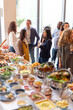 © Rawpixel.com - Vibrant social gathering with buffet.