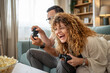 © Migma_Agency - Couple laughing while enjoying fun video game competition