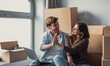 © Daniel - Happy young couple sit among cardboard boxes with a laptop, sharing a celebratory high five as they unpack and settle into their new home, showing teamwork, joy and modern city life