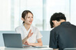 © buritora - A female staff member in a white coat comforts a male patient during a counseling session.