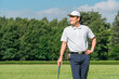 © buritora - A male golfer in golf attire amidst fresh greenery (golf course, academy, membership).